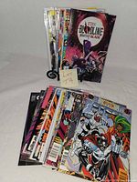 Stack of approximately 25 comic books with one issue of Bloodline Daughter of Blade displayed, others stacked and some bagged