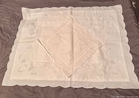 All three linen pillow covers laid flat showing sizes and scalloped edges