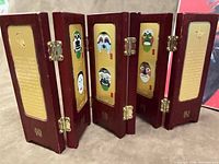 Mini folding screen partly opened showing mask panels