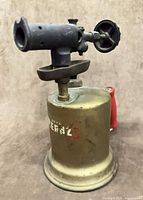 Front left view of brass tank and steel burner assembly