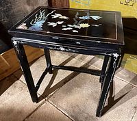 Overall view of black lacquer table showing design and structure