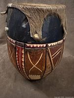 Front view showing carved geometric panels and wear