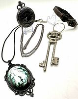 Overall view of pocket watch, cameo pendant, key keychain and bracelet