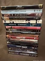 Stack of 19 DVD cases showing spines with various titles