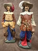 Front view of both musketeer figurines