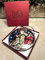 Stained glass roundel in open red Winged Heart box