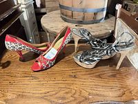 Both pairs of high heels on tabletop