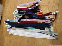 Bundle of assorted zippers laid out showing variety and quantity