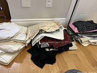 Stacked mixed fabric scraps in various colours and prints on floor