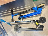 Top view of both folded scooters showing overall appearance and wear