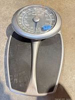 Full view of the Health o meter scale showing silver body and black foot pads