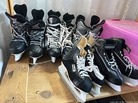 Four pairs of skates lined on table showing overall condition and styles