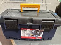 Closed toolbox front view showing brand label, latches and handle