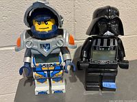 Front view of both oversized LEGO alarm clocks showing characters, digital displays, colors and condition