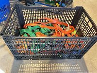 crate filled with assorted colored ratchet straps