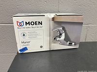 Front of Moen Manor L84683 faucet box showing product image and model