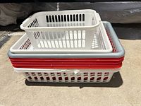 Side view of nested plastic baskets showing sizes and colored rims