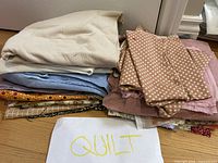 First stack showing beige, blue, tan geometric, pink and orange polka dot fabrics