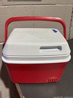 Front view of red base with white lid and red handle