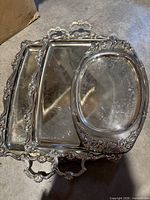 Stacked view of two rectangular trays and one oval tray showing overall design and condition