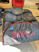 Front view showing SkipTheDishes logo, black fabric, red trim, handles