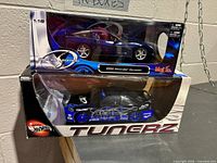 Two boxed die-cast model cars stacked: Maisto Corvette on top, Hot Wheels Civic below