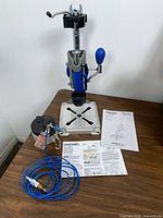 Overall view of Dremel 220 stand with manuals, hose and reservoir lid