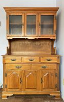 Full frontal view of Roxton two-piece hutch showing overall design, drawers, doors and finish