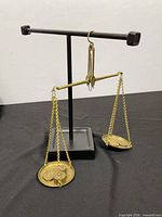 Full view of brass balance scale on display stand