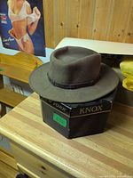 LiteFelt brown-taupe fedora resting on Knox New York hat box