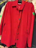 Front view of red Alfred Dunner coat showing buttons, collar and overall condition