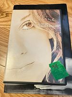 Front cover of DVD atop book