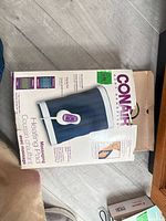 Retail box with heating pad and controller visible, shows dimensions and branding