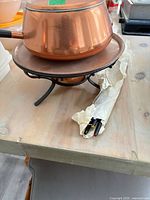 Pot on stand with wrapped forks beside