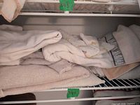 Stack of folded cotton towels on shelf