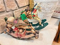 Both resin rocking horse figurines side by side