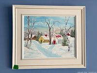 Front view of framed winter landscape painting in white frame with gold trim