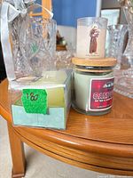 Jar candle, votive prayer candle and boxed LED flameless candle set on table