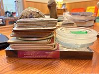 Stacked coasters showing marble boxed set, cork-backed board coasters and clear glass coasters