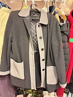 Front view of London Fog wool blend coat on hanger showing contrast trim, buttons, quilted lining and pockets