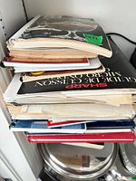 Side view of stack showing multiple cookbooks and booklets