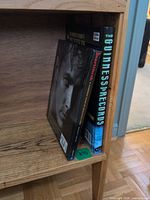 Both hardcover books standing on shelf