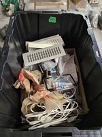 Overview of tote showing vent covers, extension cord, Milton packaged U-bolt, screws and miscellaneous hardware