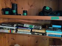 Wide view of two shelves showing multiple hardcovers and paperbacks