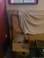 Plywood layout base set on side, cloth cover, wiring visible, Lowe’s box with accessories at base