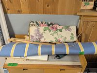 Blue striped bolt and ivory floral bolt on table