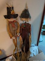 Full view of both fabric scarecrows on wooden stakes