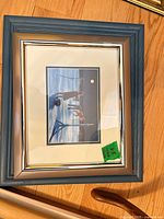blue wood framed, matted print under glass