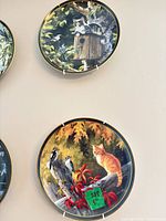 Both decorative cat-themed wall plates showing detailed artwork and included hangers