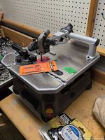 Rockwell BladeRunner scroll saw on bench with two packs of blades visible